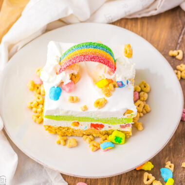 piece of Lucky Charms layered dessert with marshmallows and a candy rainbow