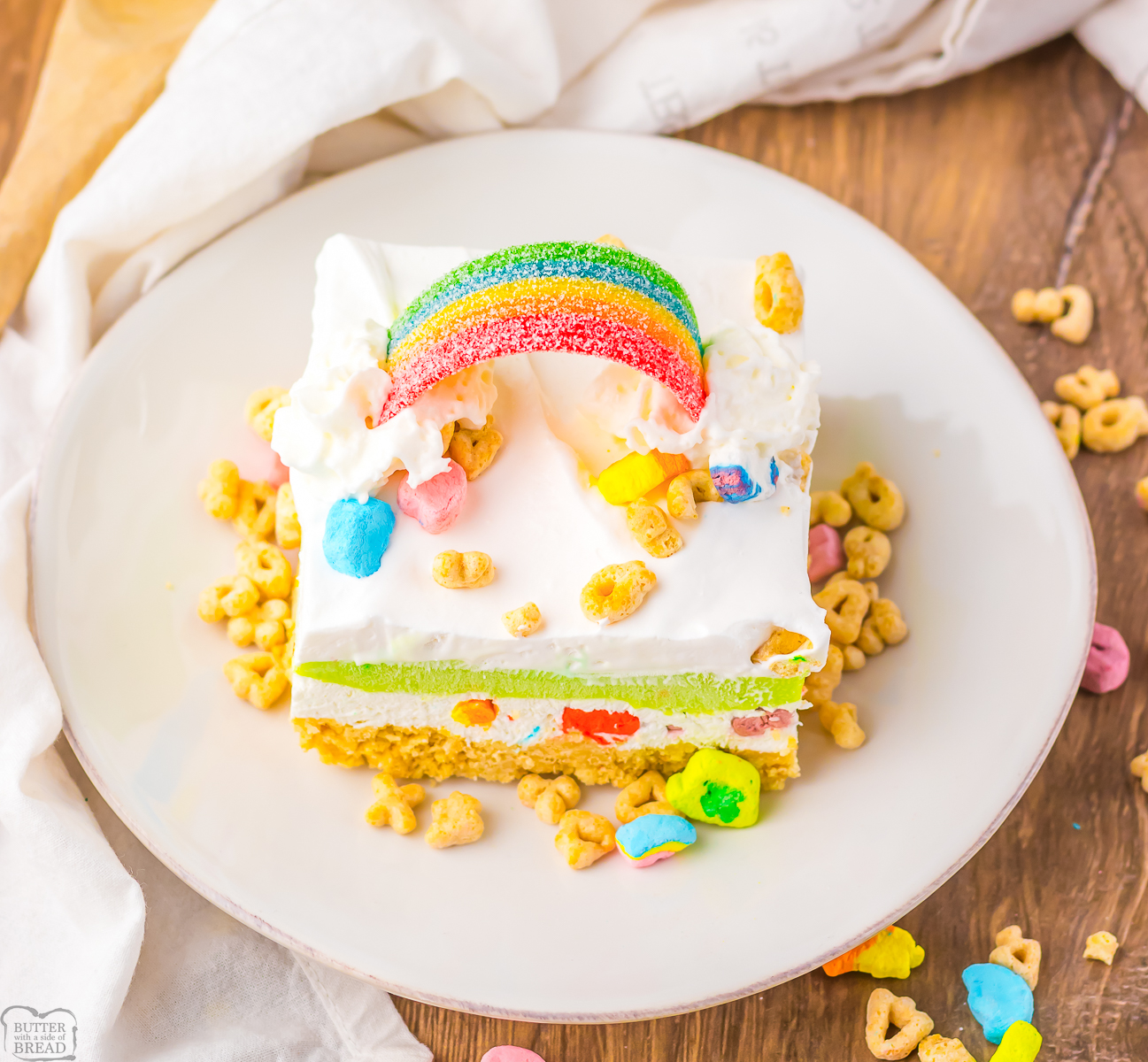 piece of Lucky Charms layered dessert with marshmallows and a candy rainbow