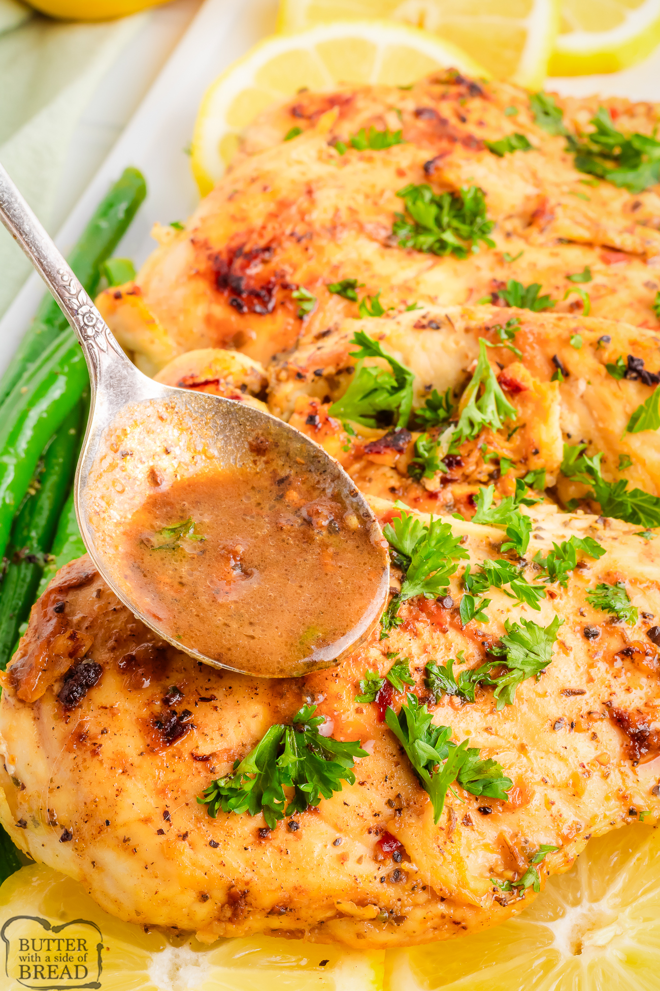 drizzling sauce on lemon garlic chicken
