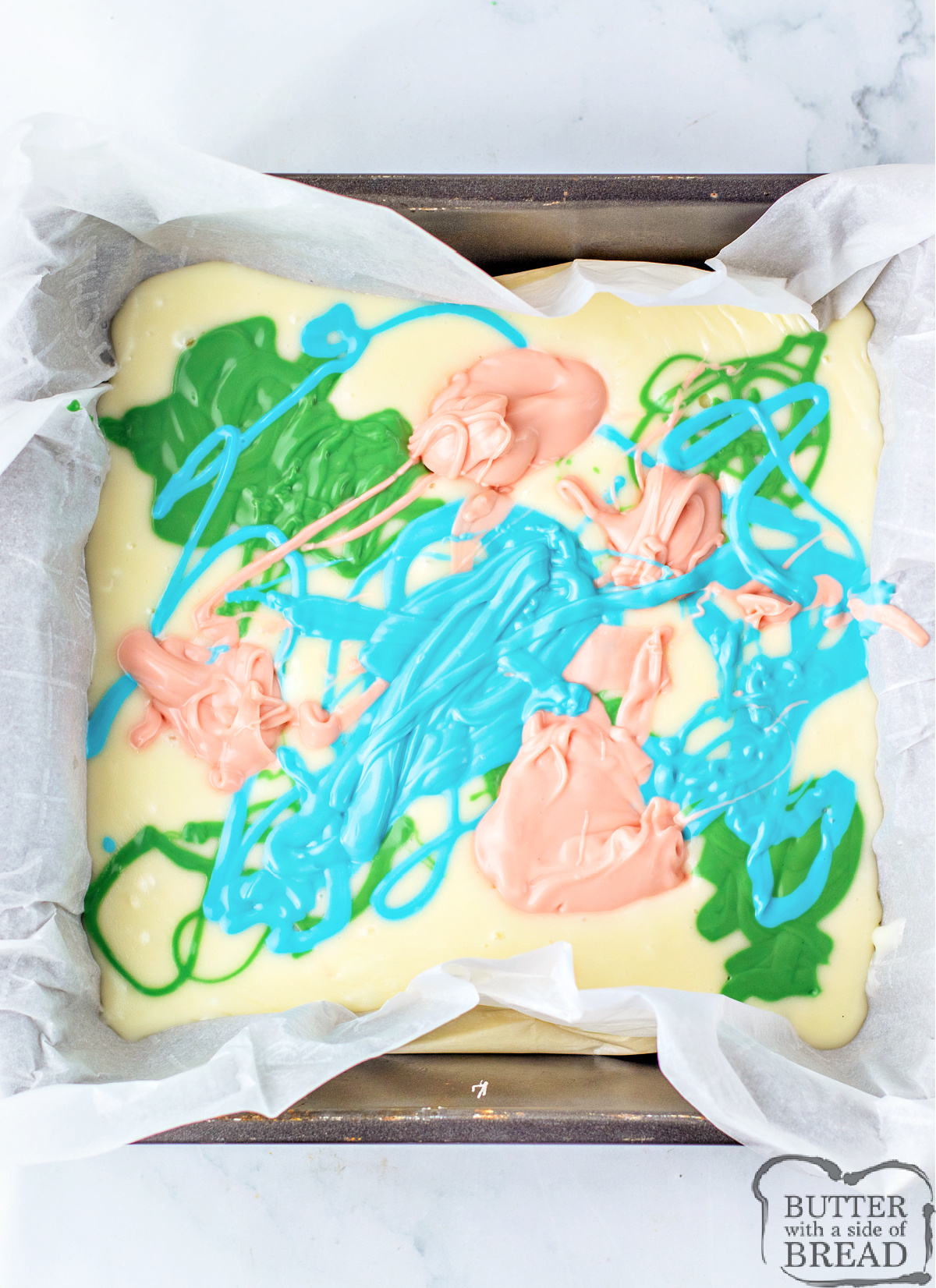 Swirl colored candy melts onto white chocolate layer.