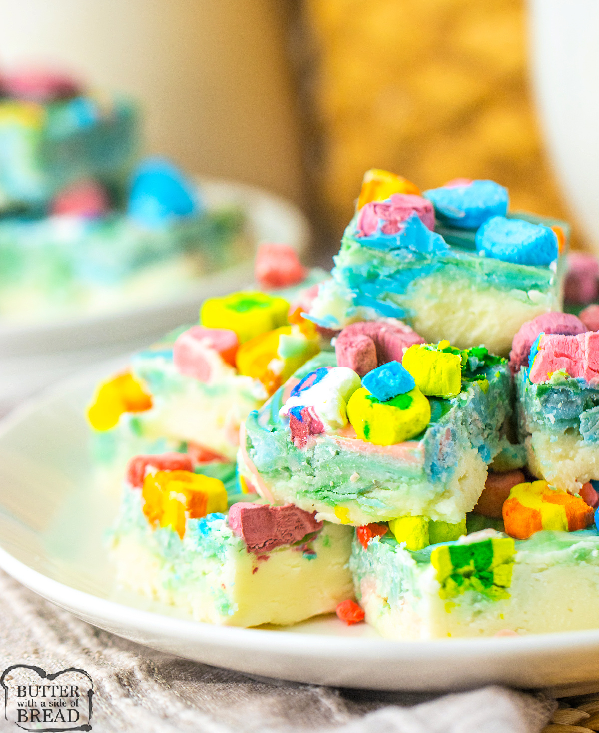 Lucky Charms Fudge is made with white chocolate chips, vanilla frosting, colored candy melts, and Lucky Charms marshmallows. This colorful fudge recipe requires only four ingredients and a microwave!