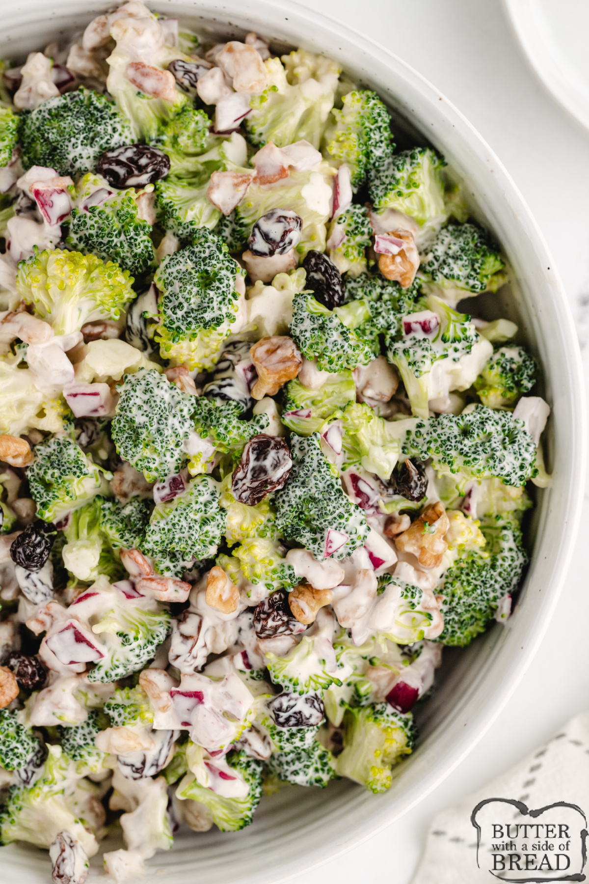 Bacon and Broccoli Salad is made with walnuts, raisins, and onion in a simple, sweet, and creamy dressing. This salad is the perfect side dish for most meals and is a wonderful choice for potlucks and parties!