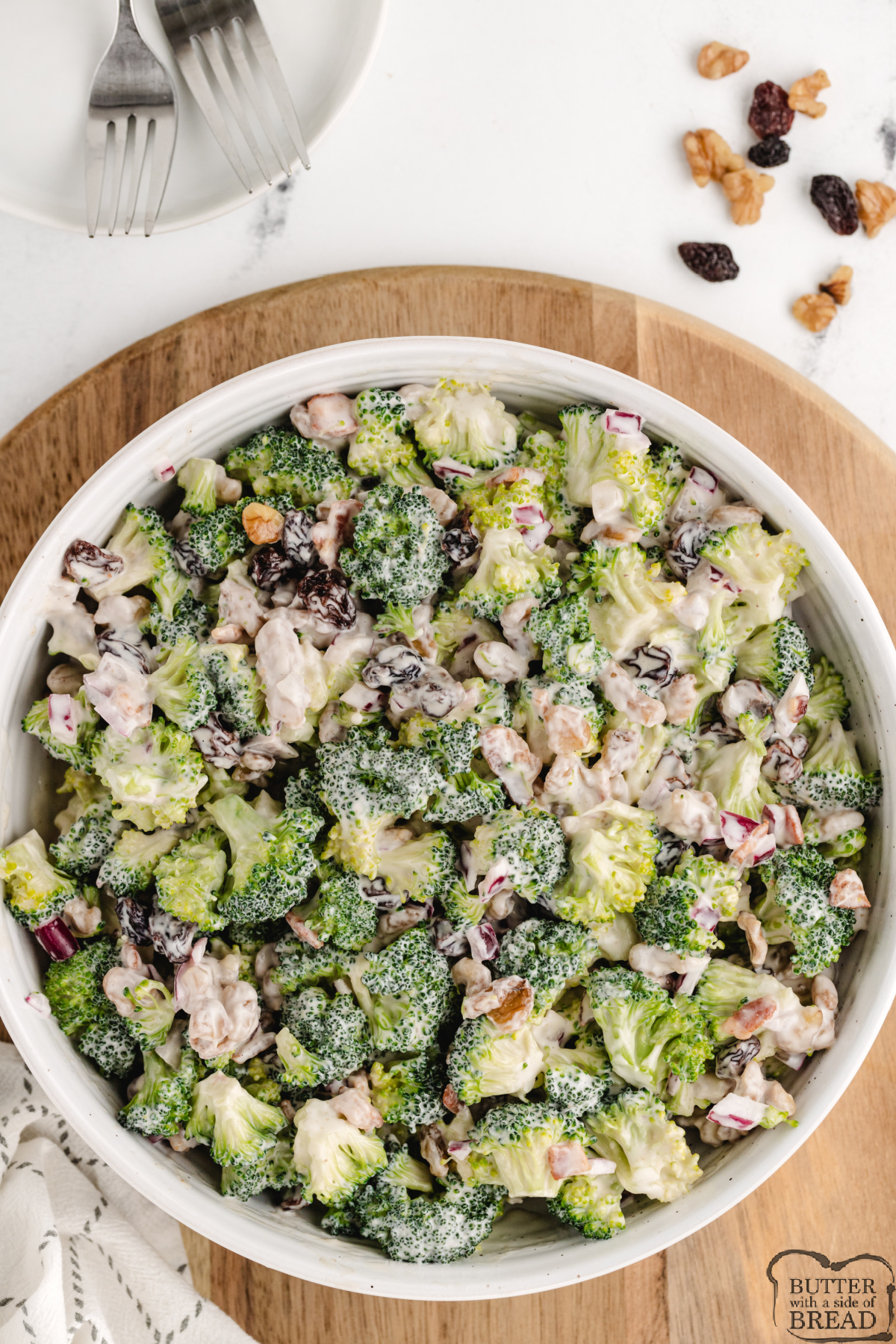 Bacon and Broccoli Salad is made with walnuts, raisins, and onion in a simple, sweet, and creamy dressing. This salad is the perfect side dish for most meals and is a wonderful choice for potlucks and parties!