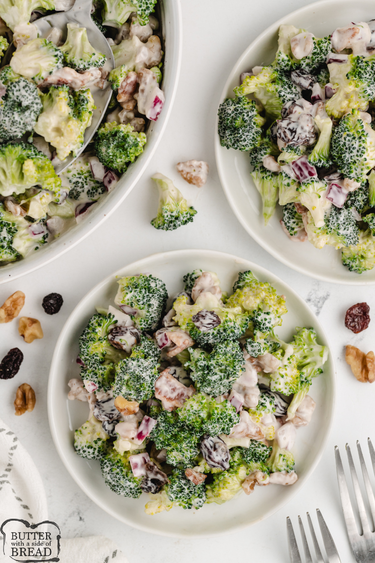Salad made with broccoli, nuts, raisins, and bacon.