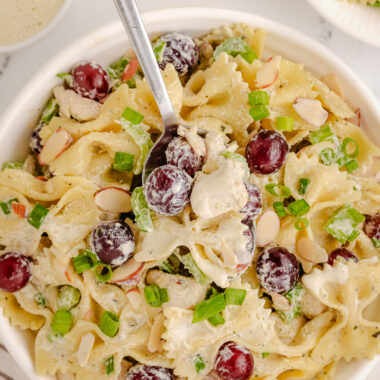 scooping a serving of lemon tarragon pasta salad