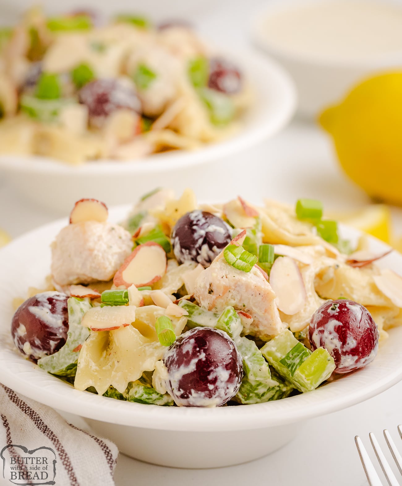 bowl of lemon tarragon pasta salad with grapes and almonds