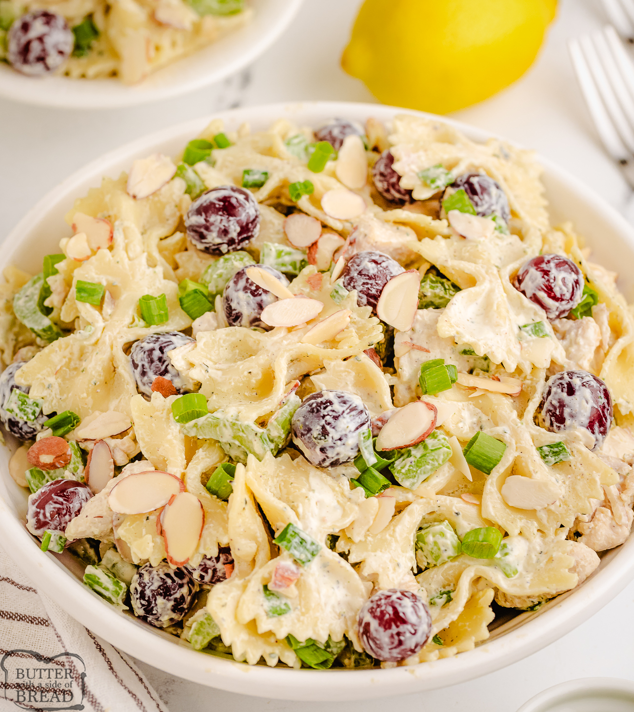 big bowl of lemon tarragon pasta salad with chicken and grapes