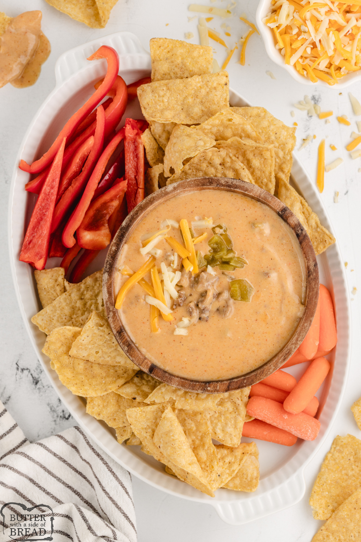 High protein queso dip with peppers, chips, and carrots.