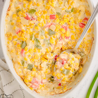 creamed corn casserole in a white baking dish