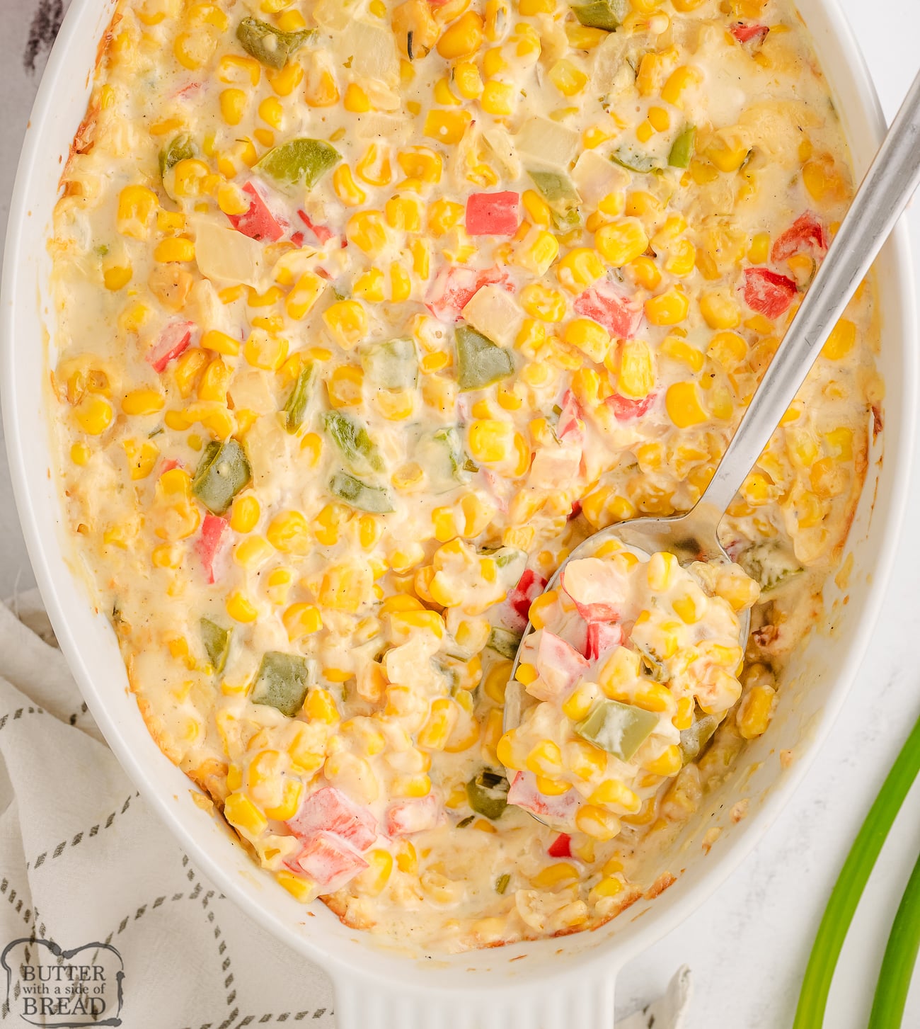 creamed corn casserole in a white baking dish
