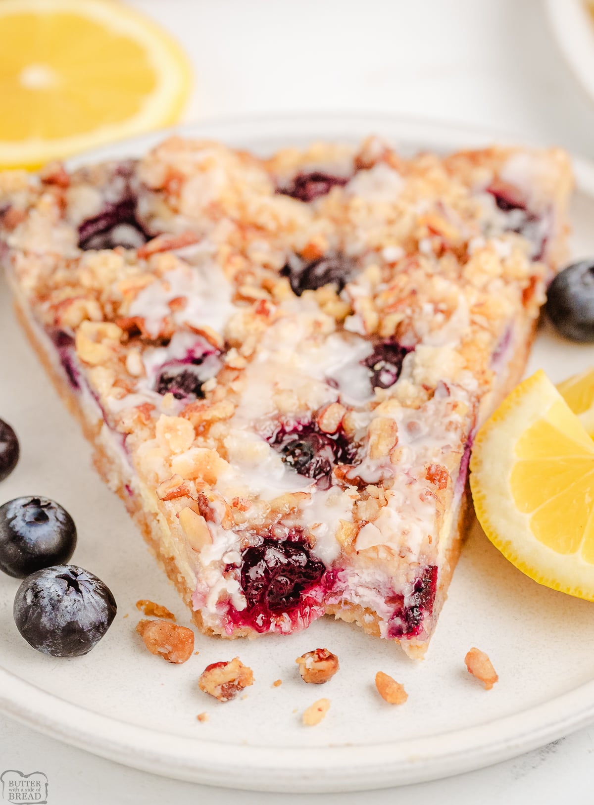 slice of lemon blueberry dessert pizza with a bite taken out