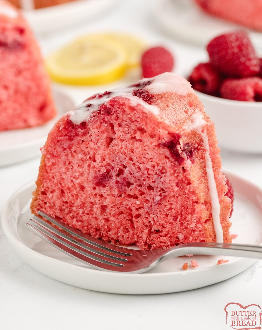 Slice of raspberry cake with lemon glaze.