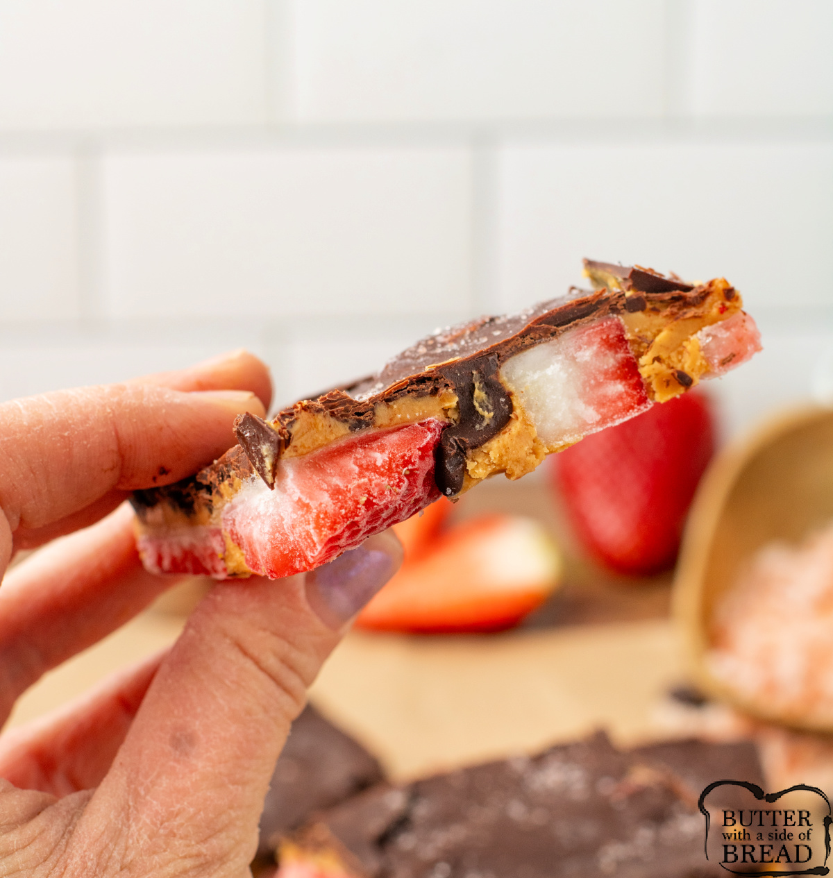 Piece of strawberry peanut butter bark made with dark chocolate.