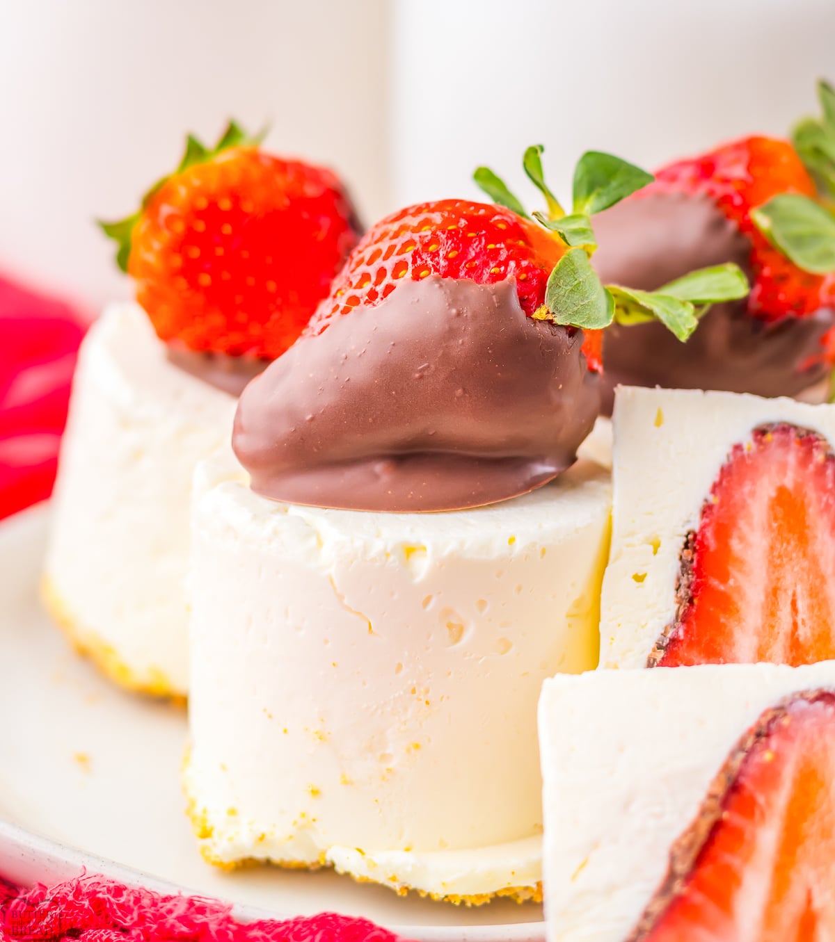 no bake cheesecakes topped with a chocolate strawberry