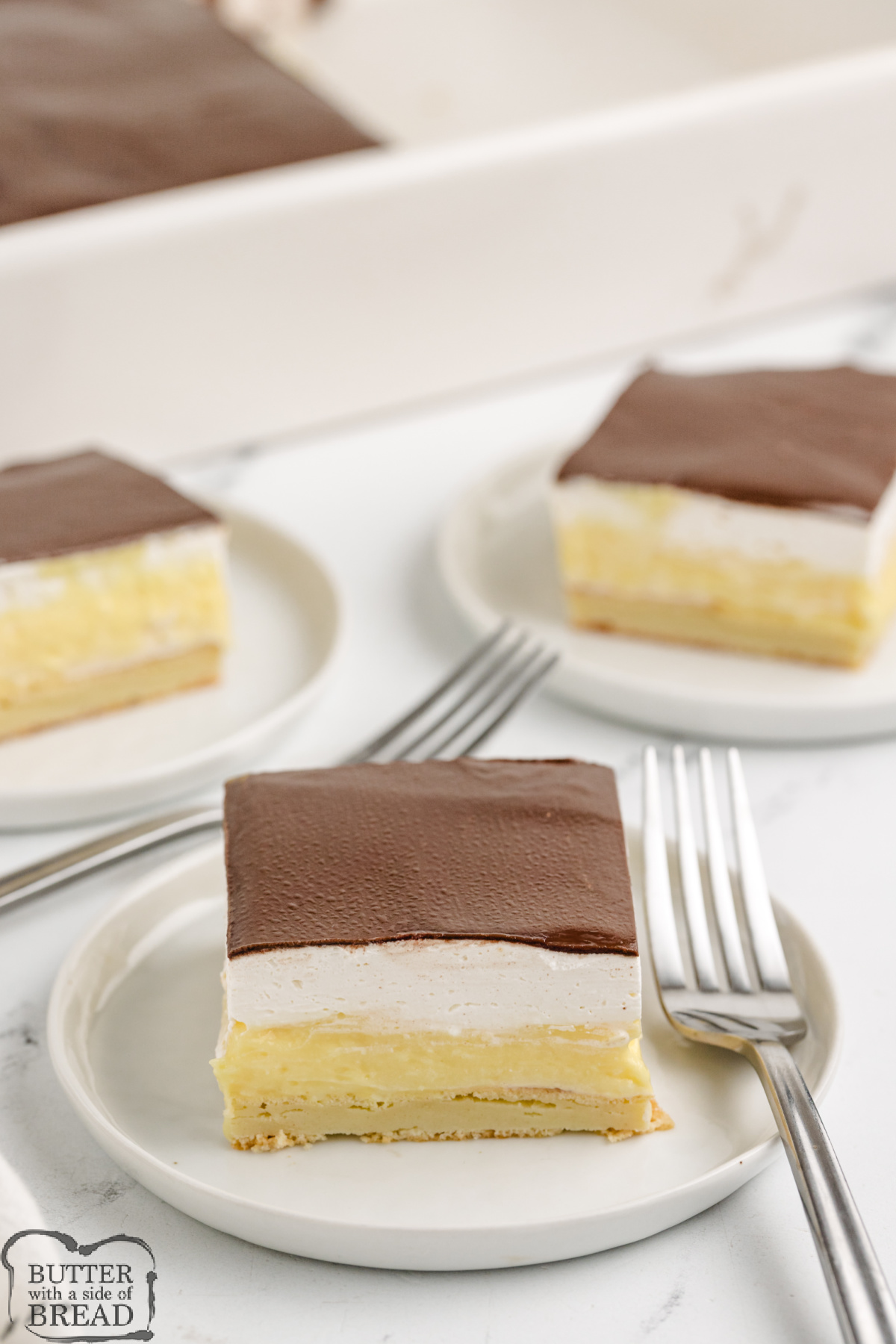Easy Chocolate Eclair Cake has a pastry crust, creamy custard filling, and rich chocolate topping&mdash;perfect no-fuss dessert for a crowd.
