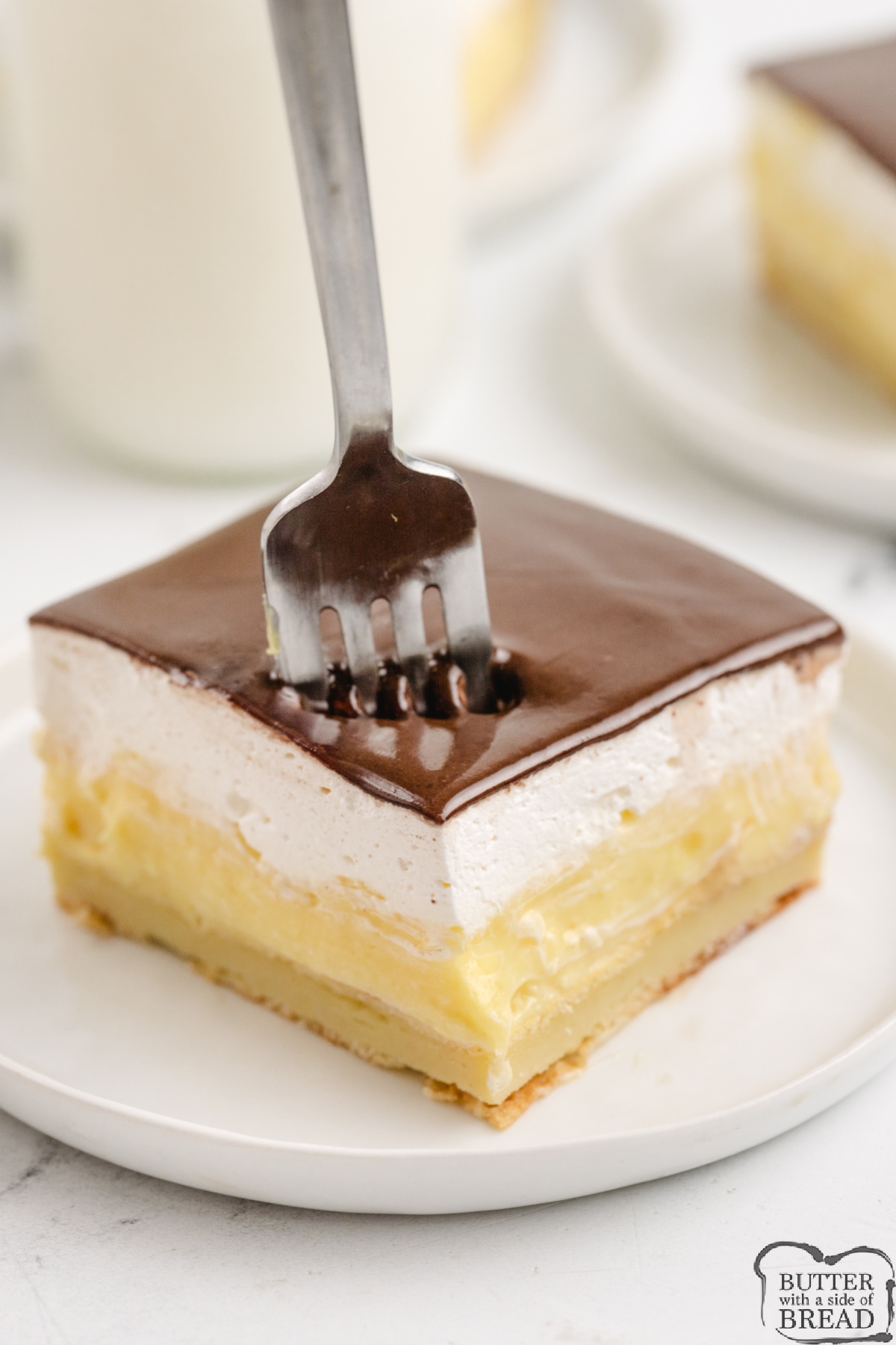 Easy Chocolate Eclair Cake has a pastry crust, creamy custard filling, and rich chocolate topping&mdash;perfect no-fuss dessert for a crowd.