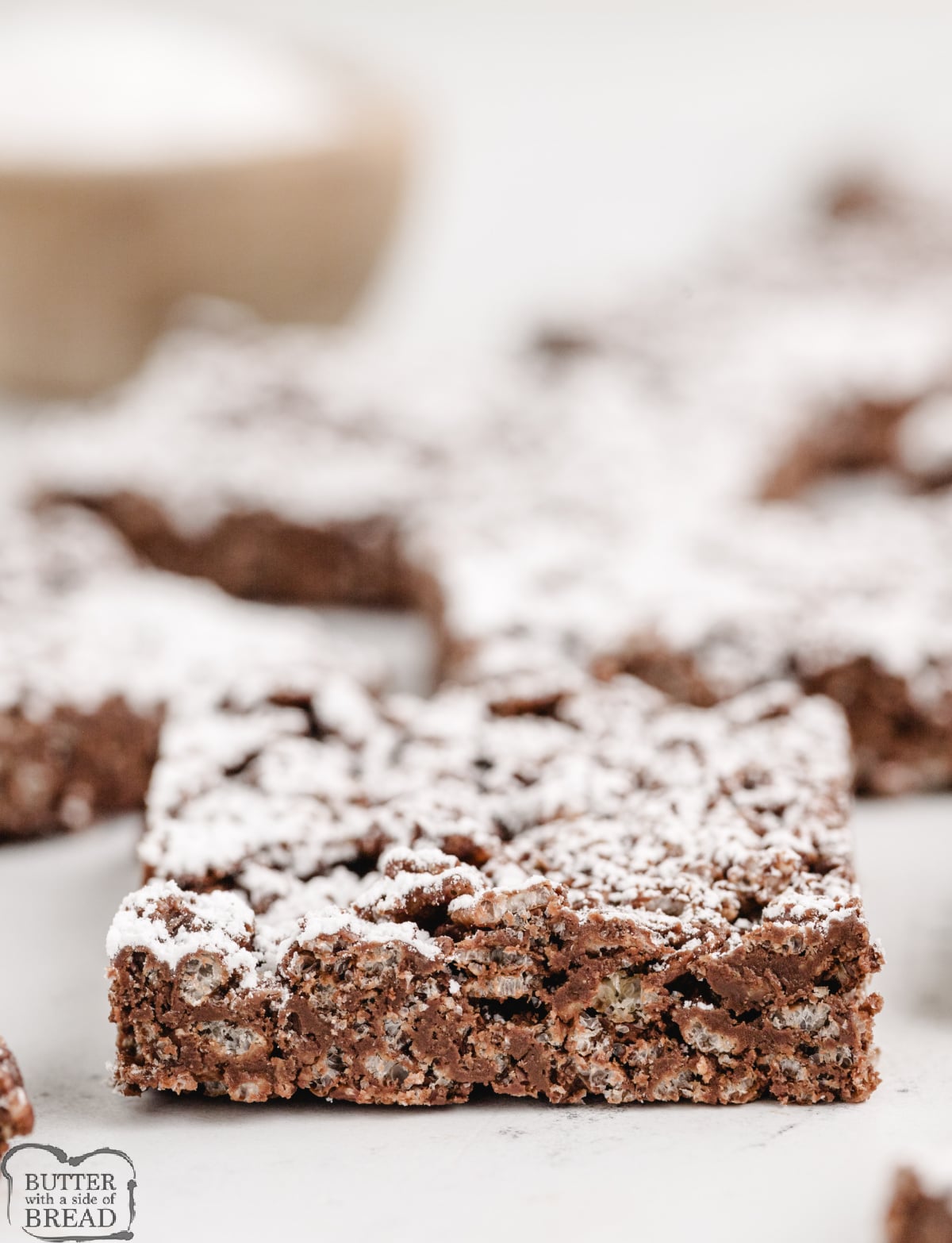 Rice krispie treats made with chocolate chips, peanut butter, and powdered sugar.
