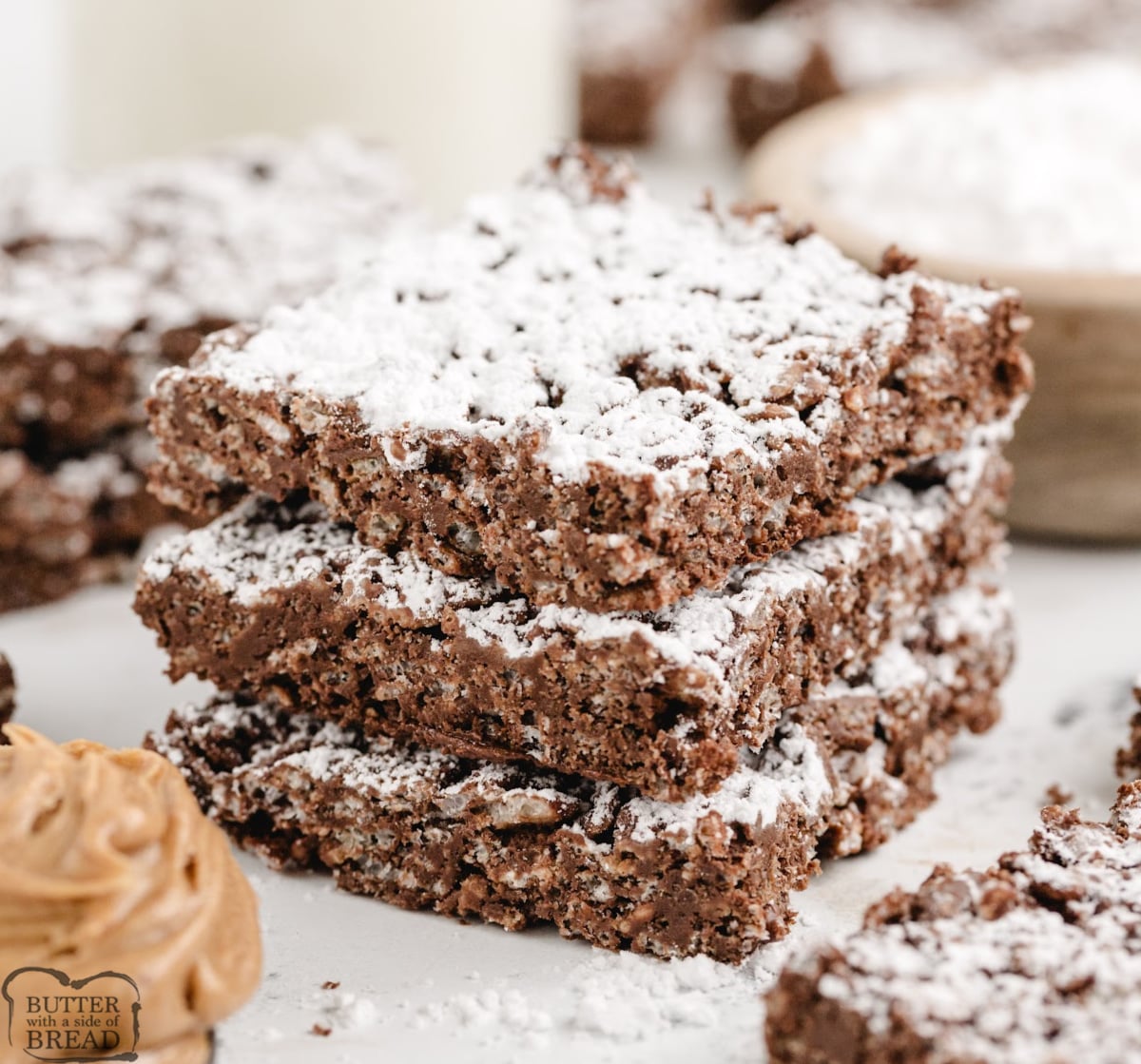 These no-bake Muddy Buddy Rice Krispie Treats are packed with peanut butter, chocolate, and powdered sugar. Easy to make, fun to slice, and totally irresistible!