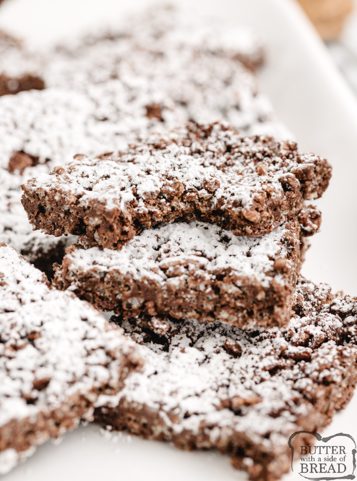 These no-bake Muddy Buddy Rice Krispie Treats are packed with peanut butter, chocolate, and powdered sugar. Easy to make, fun to slice, and totally irresistible!