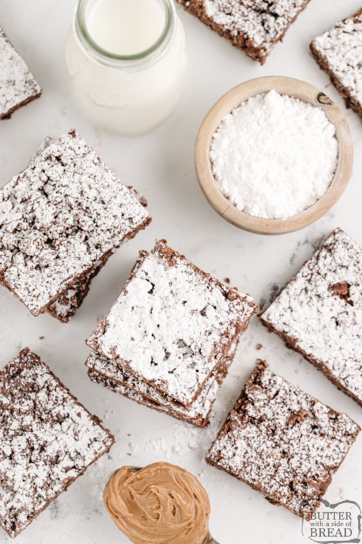 These no-bake Muddy Buddy Rice Krispie Treats are packed with peanut butter, chocolate, and powdered sugar. Easy to make, fun to slice, and totally irresistible!