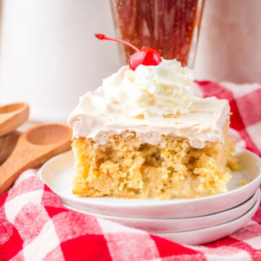 slice of root beer poke cake with a red checkered tablecloth