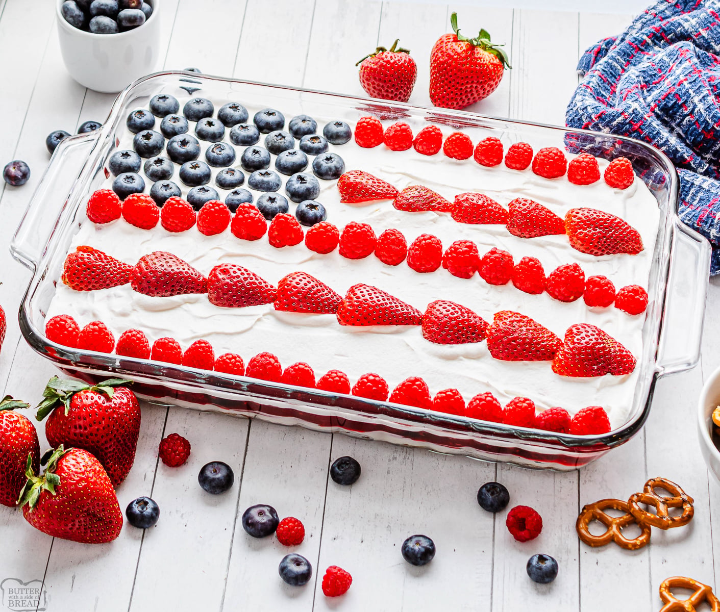 Jello Pretzel Salad with a patriotic flag on top in berries
