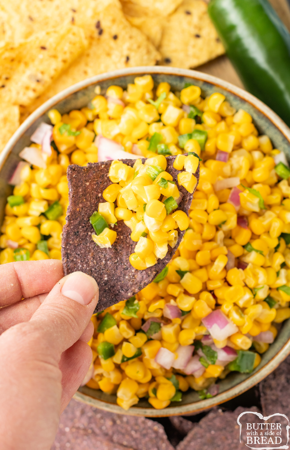 Chip dipped in corn salsa.