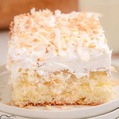 pina colada cake topped with whipped cream and coconut