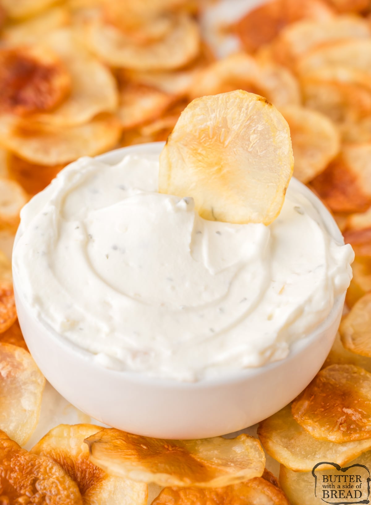 Homemade potato chip dipped in ranch dip.