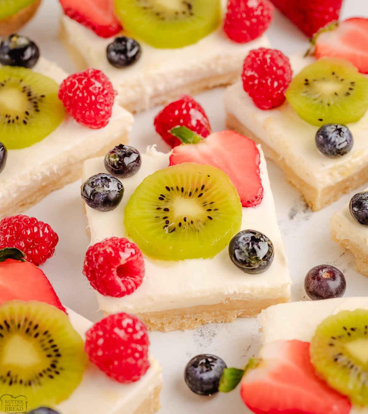 kiwi berry cheesecake bars on a white plate
