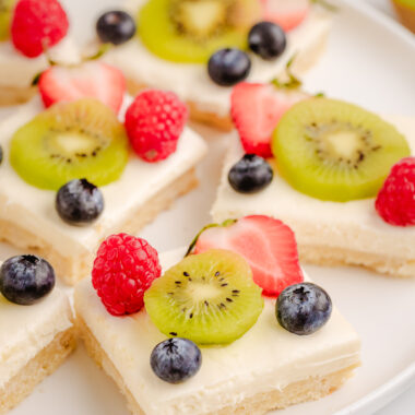 kiwi berry cheesecake bars brushed with an orange glaze