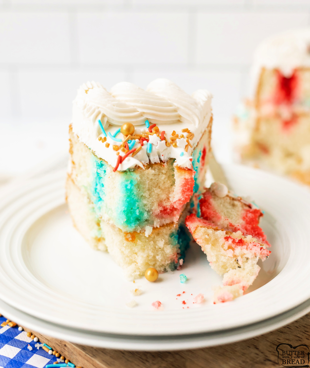 Patriotic Poke Cake is a red, white & blue layered cake filled with Jello and topped with creamy frosting&mdash;perfect for July 4th!