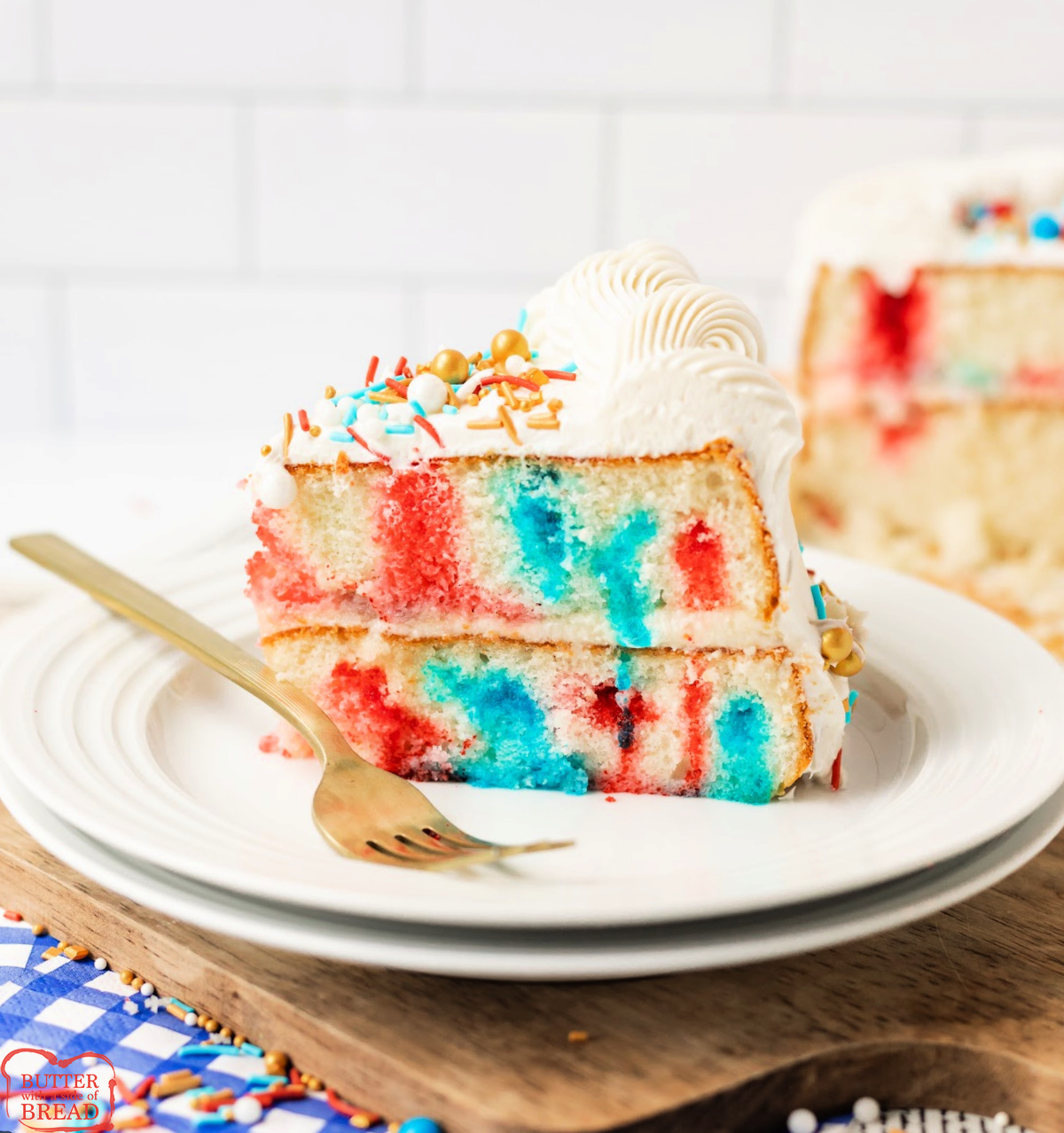 Patriotic Poke Cake is a red, white & blue layered cake filled with Jello and topped with creamy frosting&mdash;perfect for July 4th!