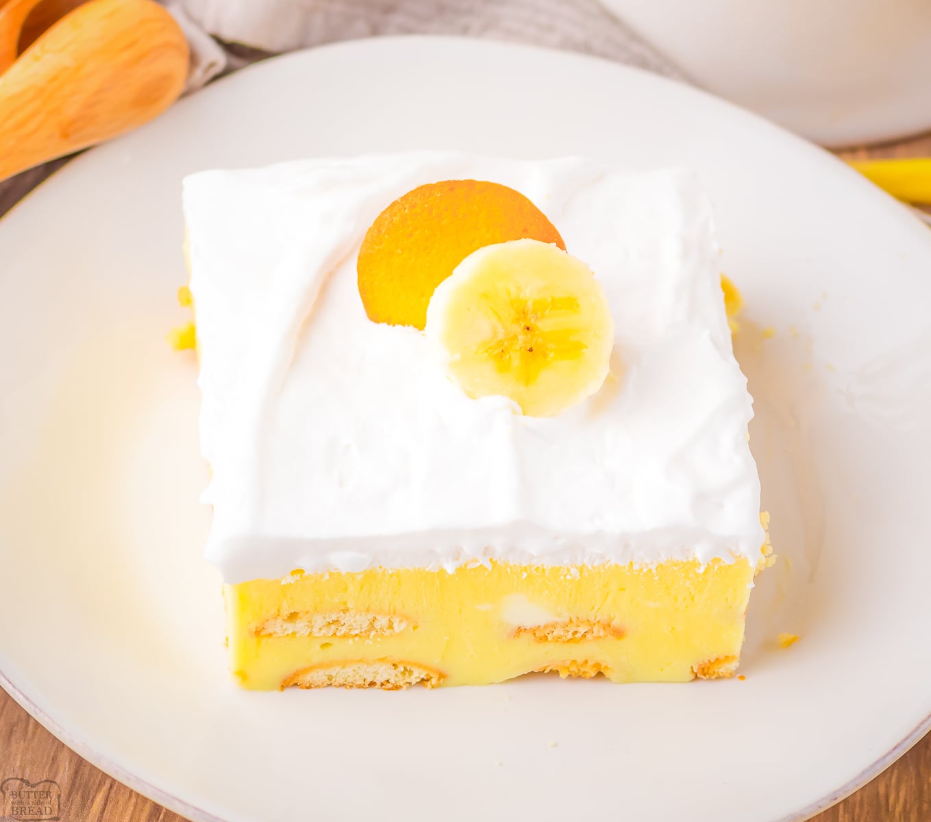 banana cream icebox cake topped with whipped cream and bananas