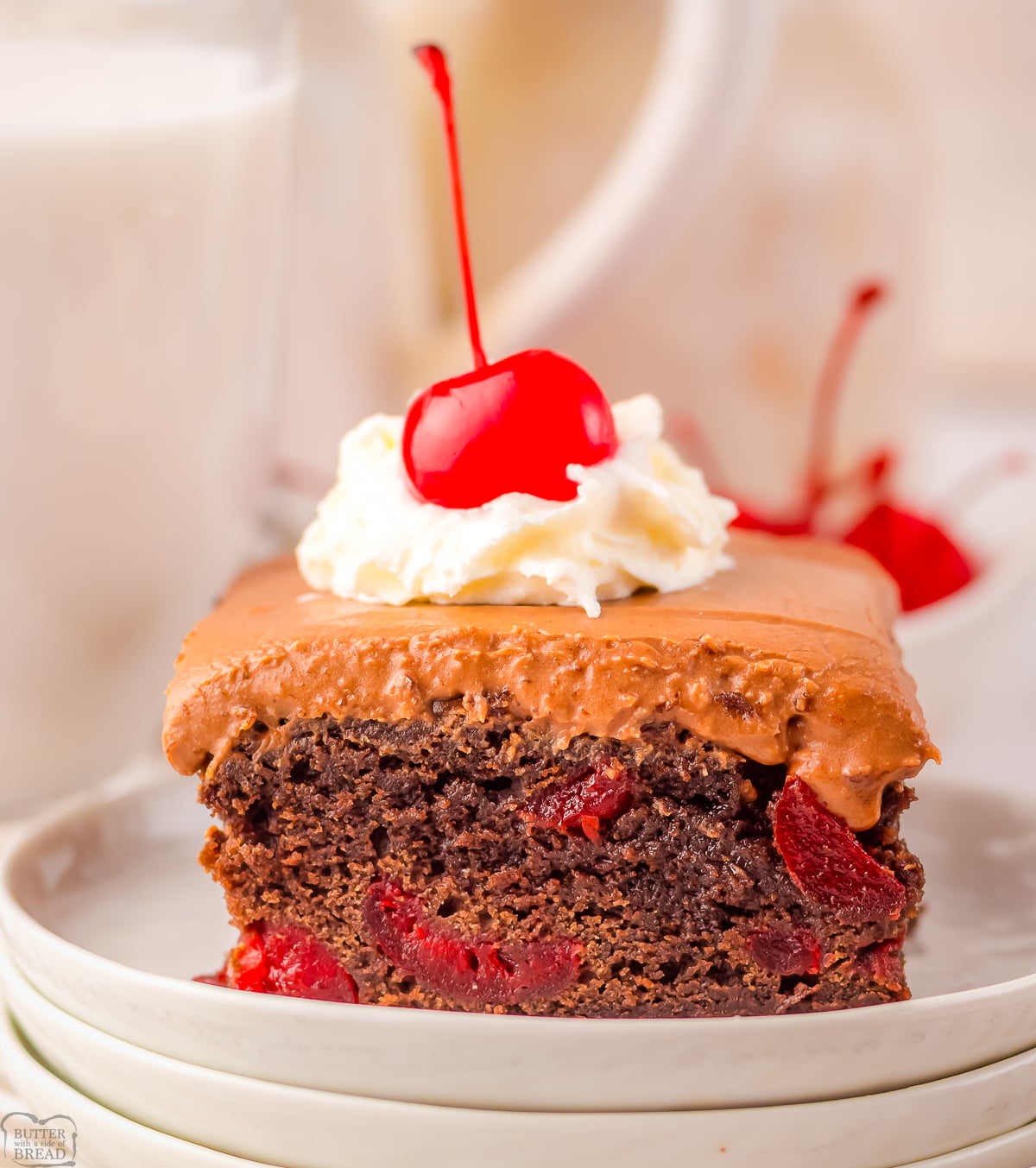 cherry coke brownies topped with whipped cream and a cherry