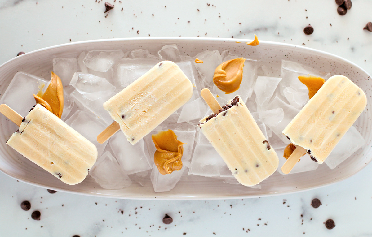 Chocolate Peanut Butter Frozen Yogurt Bars are the perfect healthy-ish frozen treat! Creamy yogurt, peanut butter, and chocolate chips make this easy no-bake recipe a summer favorite.