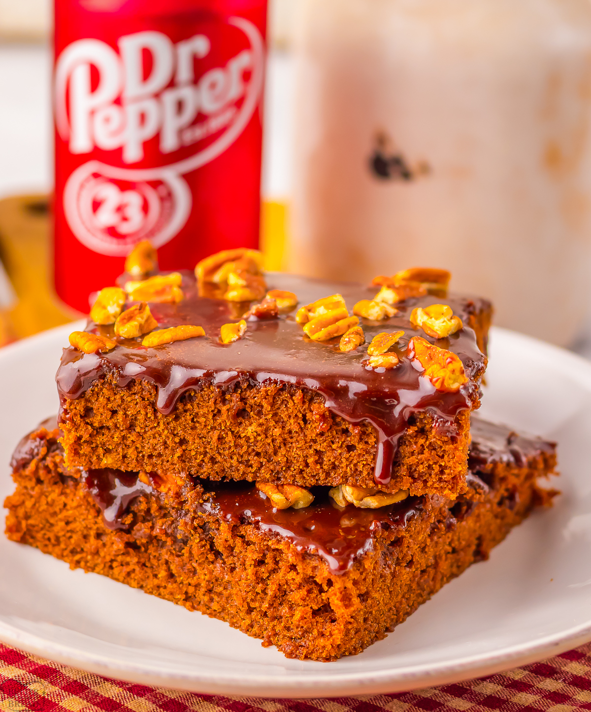 sliced of Dr Pepper chocolate sheet cake with a can in the back