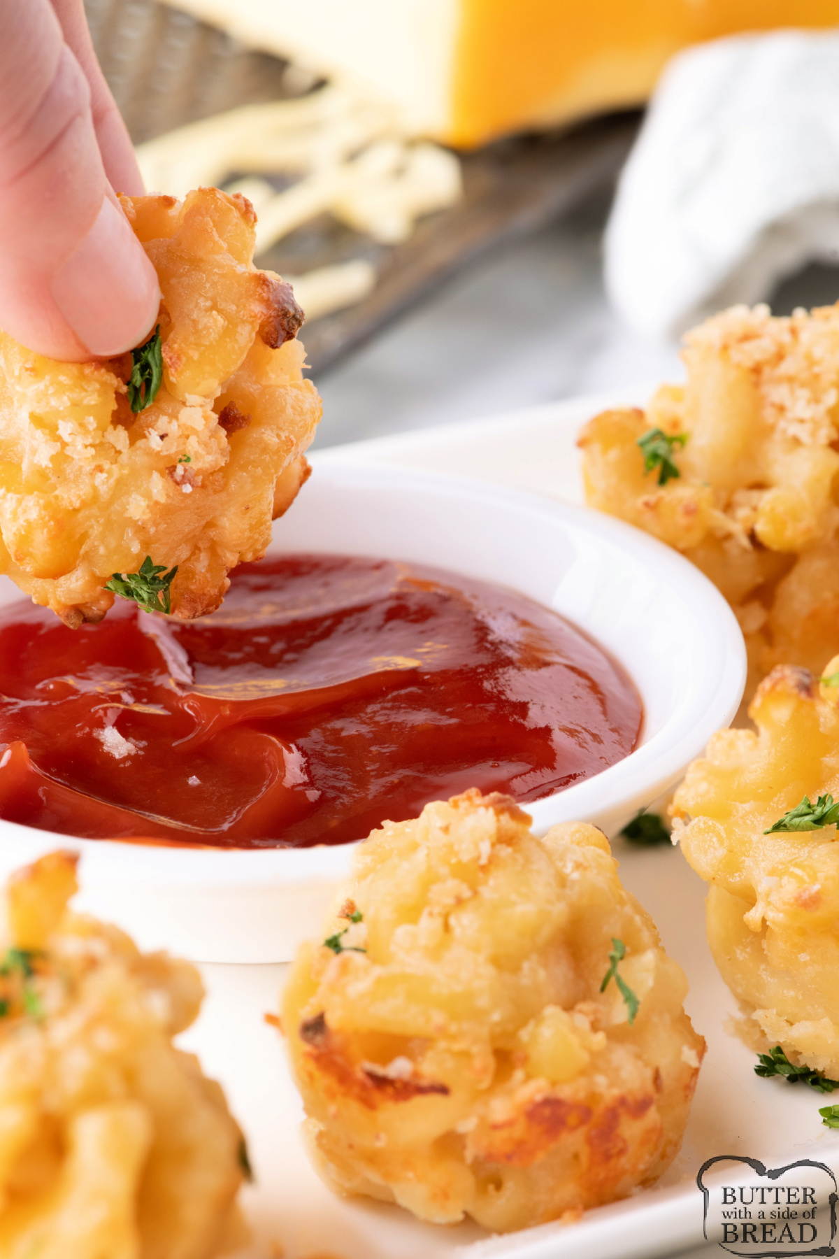 Dipping a Mac and Cheese Bite into ketchup.
