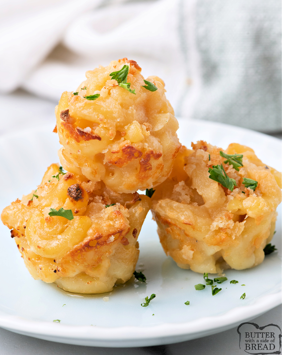 Mini mac and cheese cups made with bubbling cheese and toasted breadcrumbs.