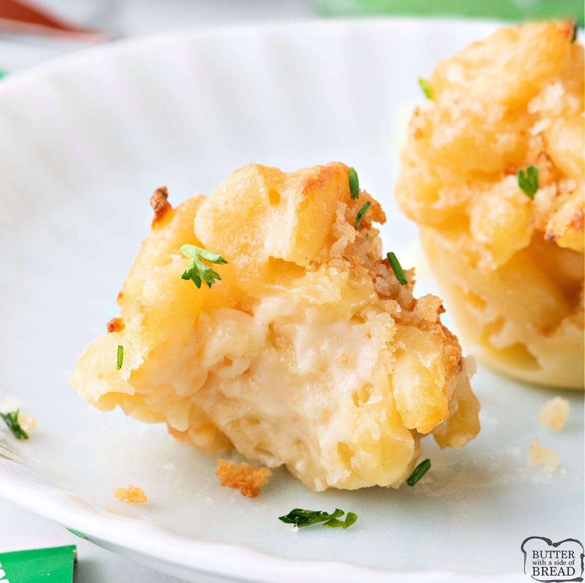 Close-up of a baked mac and cheese bite showing crunchy edges and soft interior.