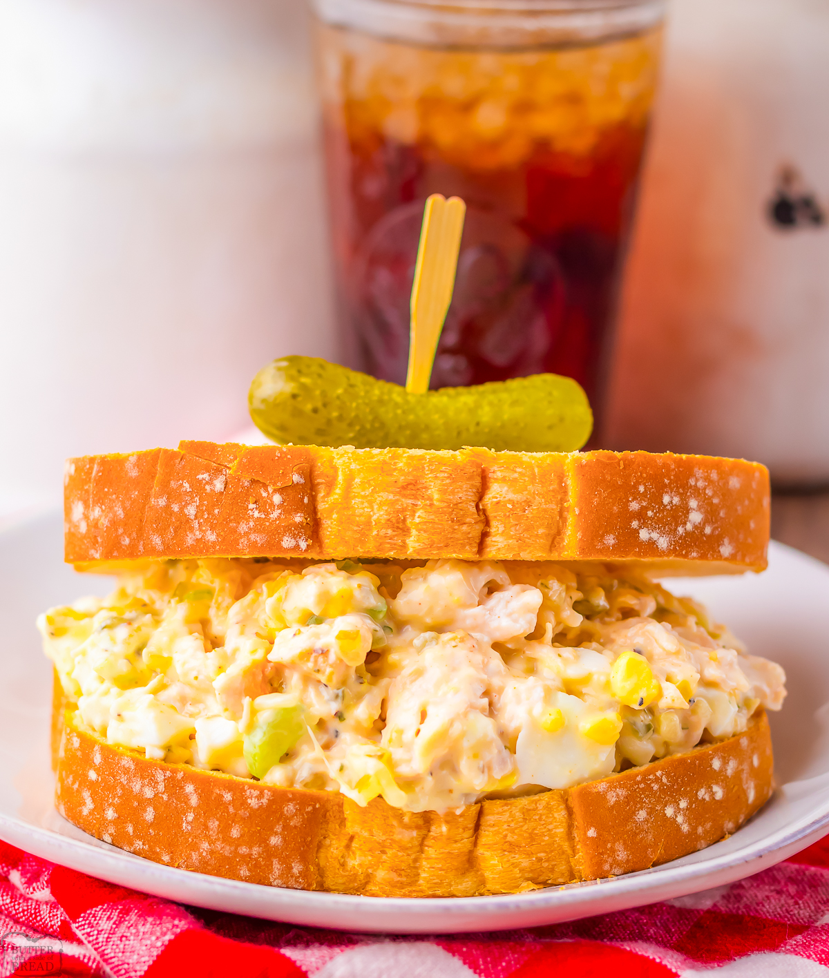 old fashioned southern chicken salad sandwich on wheat bread with a pickle