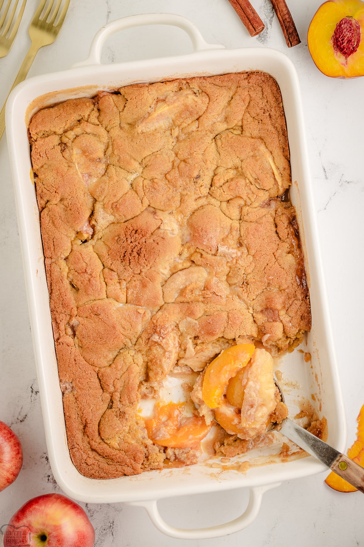 Apple and Peach Cobbler in a baking dish with a scoop taken out