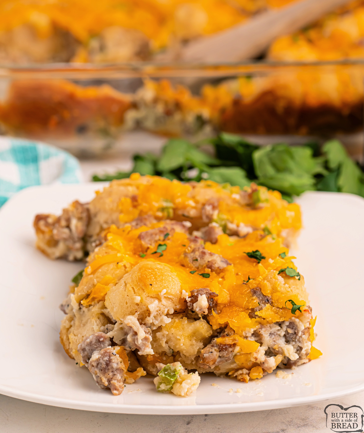 Biscuits and Gravy Casserole combines fluffy biscuits, savory sausage, creamy gravy & cheddar cheese in one easy, hearty breakfast bake!
