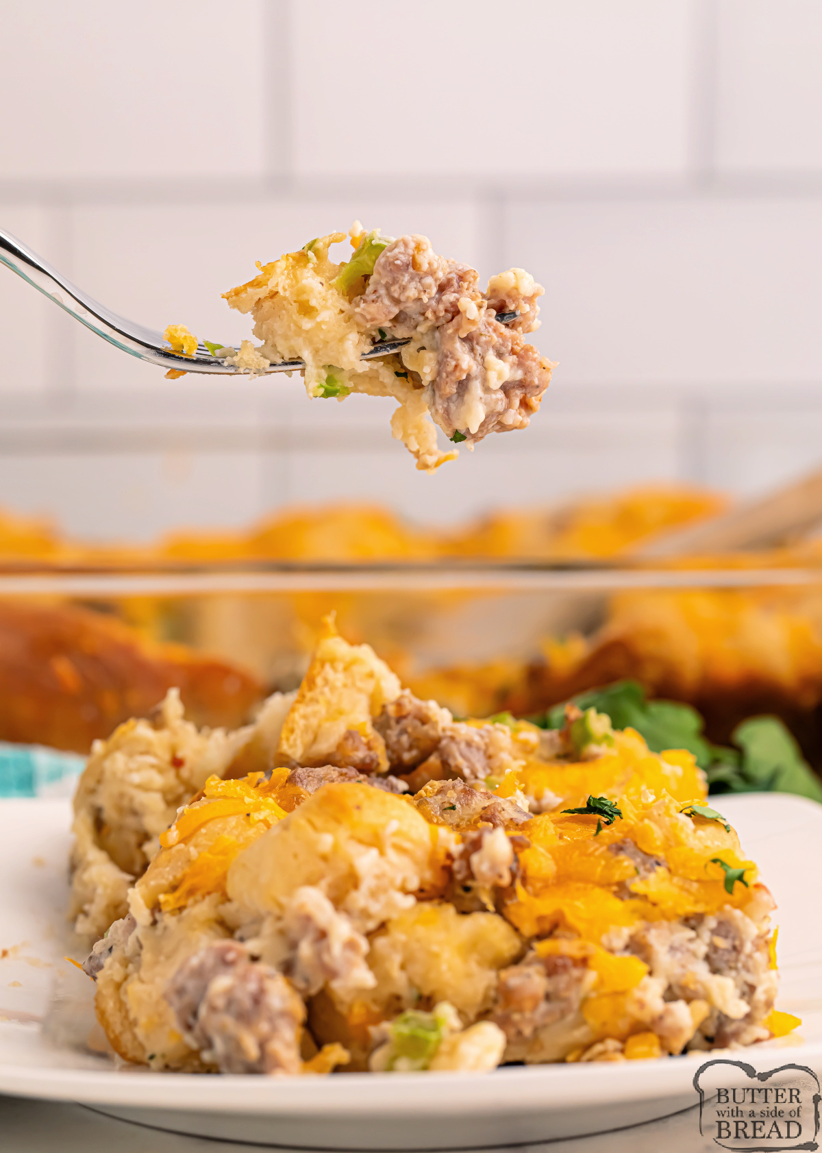 Biscuits and Gravy Casserole combines fluffy biscuits, savory sausage, creamy gravy & cheddar cheese in one easy, hearty breakfast bake!