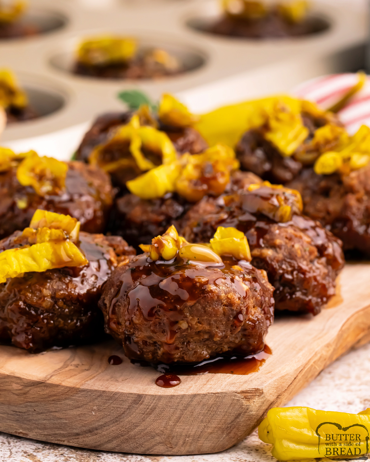 Mississippi Meatloaf Muffins are mini meatloaves baked in a muffin tin, topped with savory gravy sauce and tangy banana peppers.