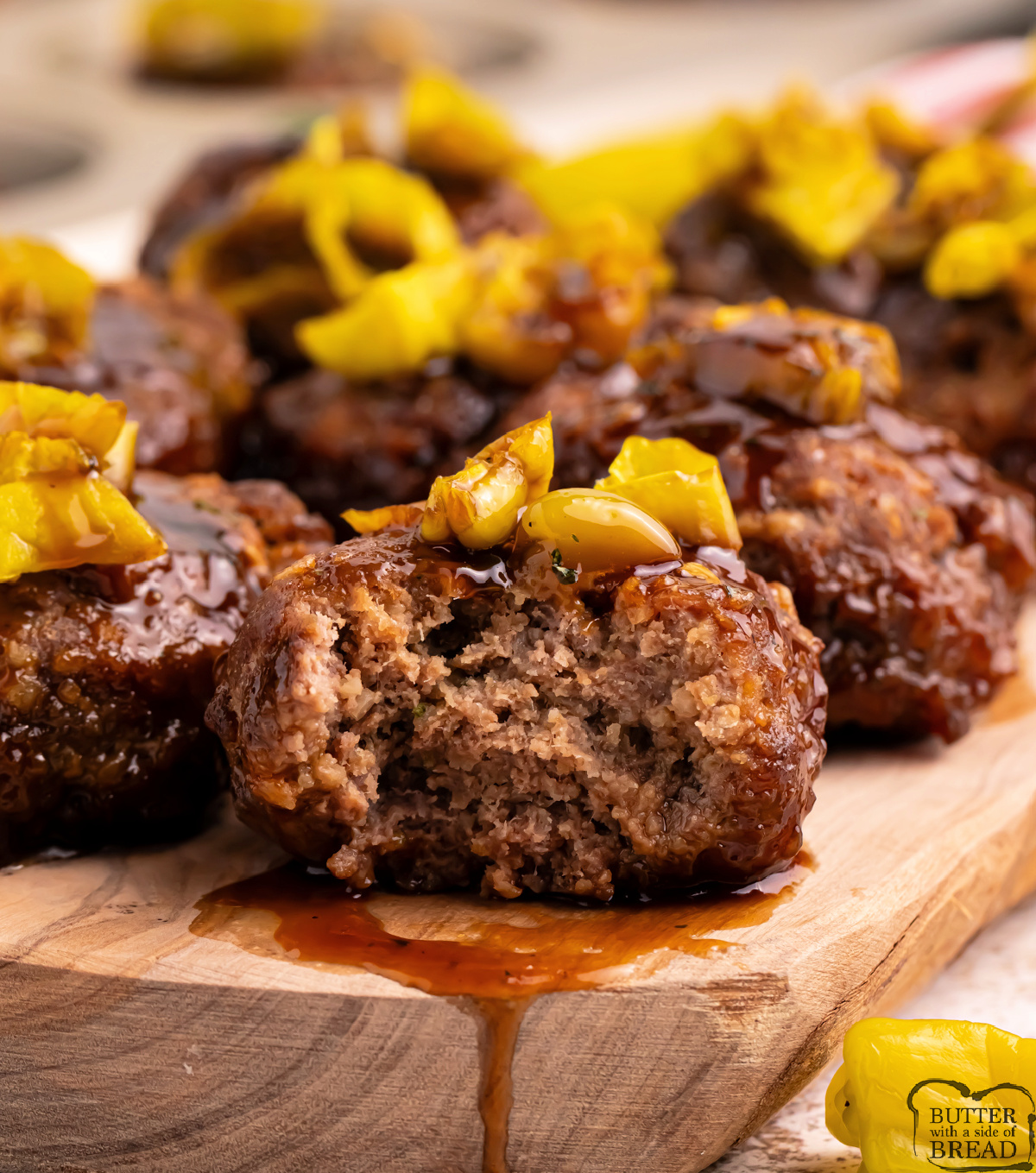 Mississippi Meatloaf Muffins are mini meatloaves baked in a muffin tin, topped with savory gravy sauce and tangy banana peppers.