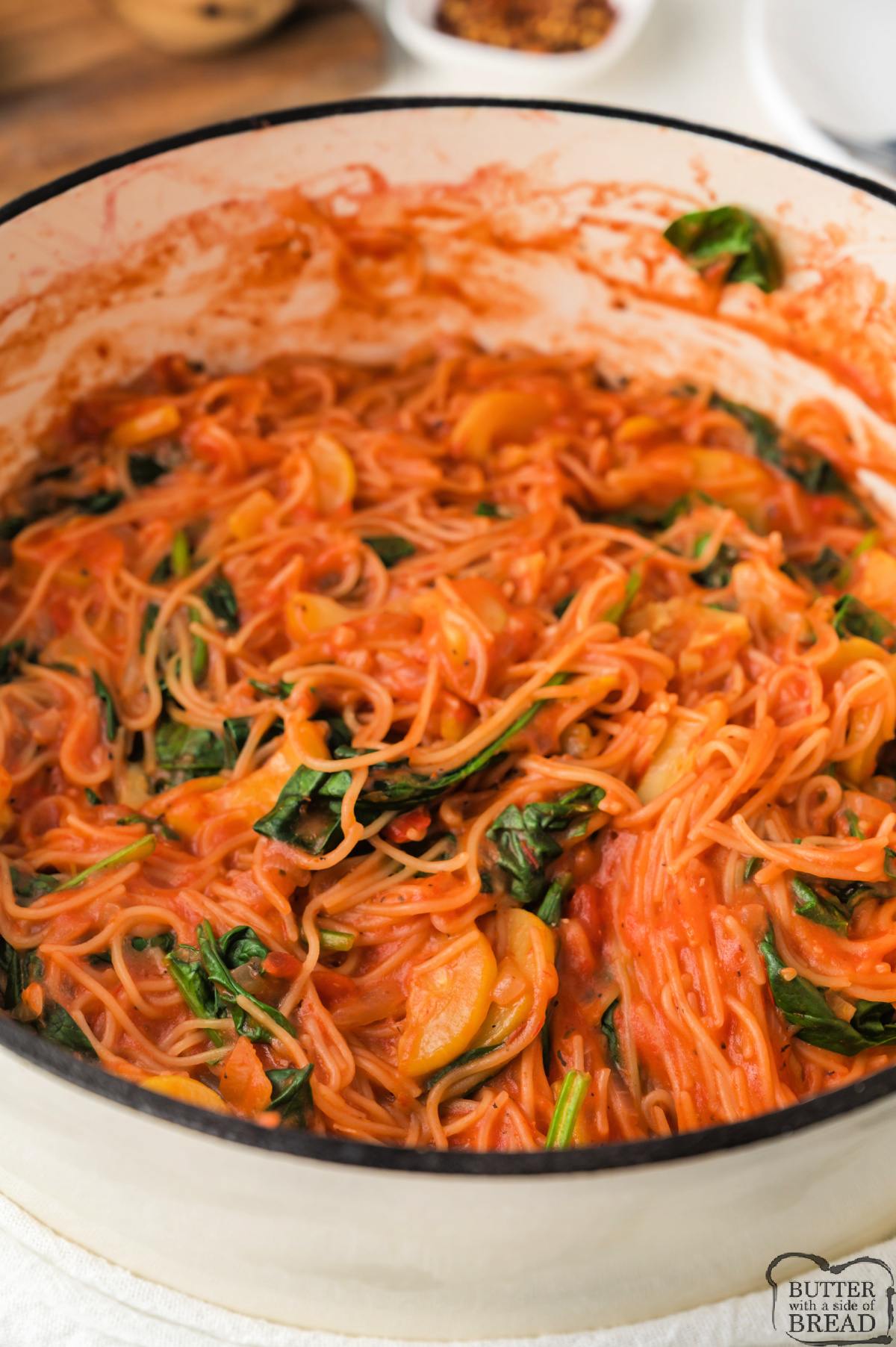 Pot of spaghetti with veggies.