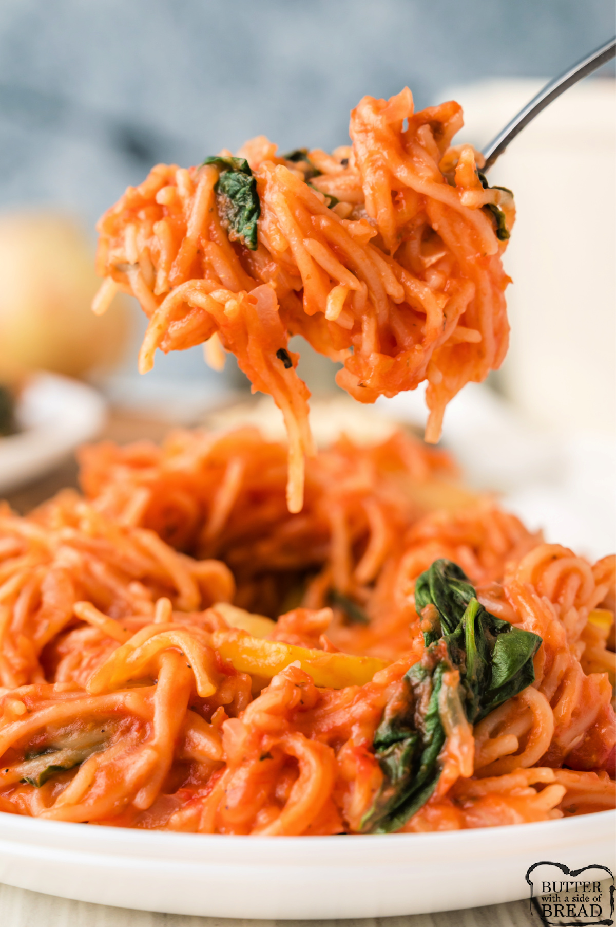 Forkful of spaghetti with veggies.