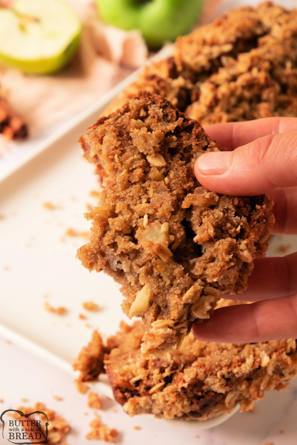 Piece of chewy oatmeal bread recipe made with apples. 