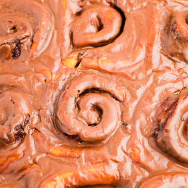 homemade cinnamon rolls topped with chocolate icing